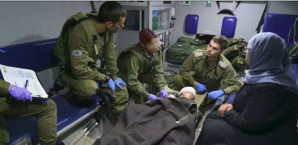 Una mujer siria con su hijo, atendido por soldados israelíes, transportados en ambulancia, desde la frontera, a un hospital israleí. (Foto: Dover Tzahal)