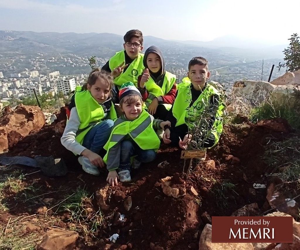 Chicos plantando árboles en memoria de los mártires