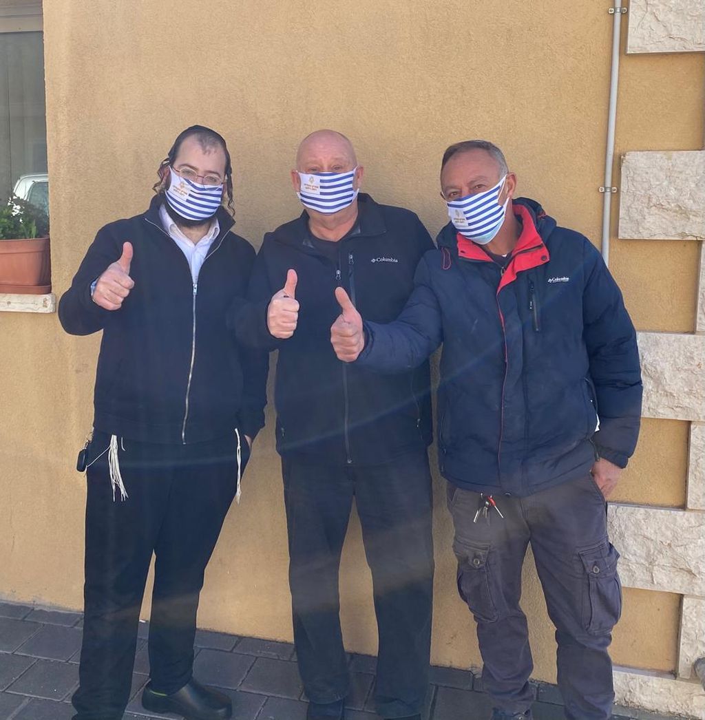 Lalo, en el medio, con dos de los trabajadores en el lugar, de distintos sectores de la sociedad israelí