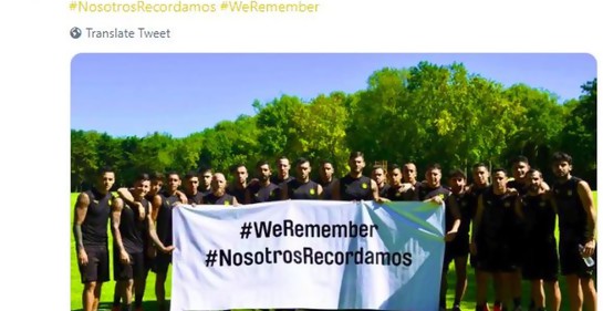 El plantel de Peñarol con la pancarta blanca en la que dice el hashtag WeRemember con la traducción al español NosotrosRecordamos