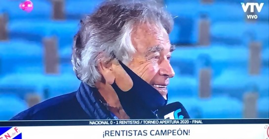 Mario Bursztyn con tapbocas, de fondo, asientos del estadio